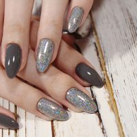 sexy gray manicure on a trendy texture background